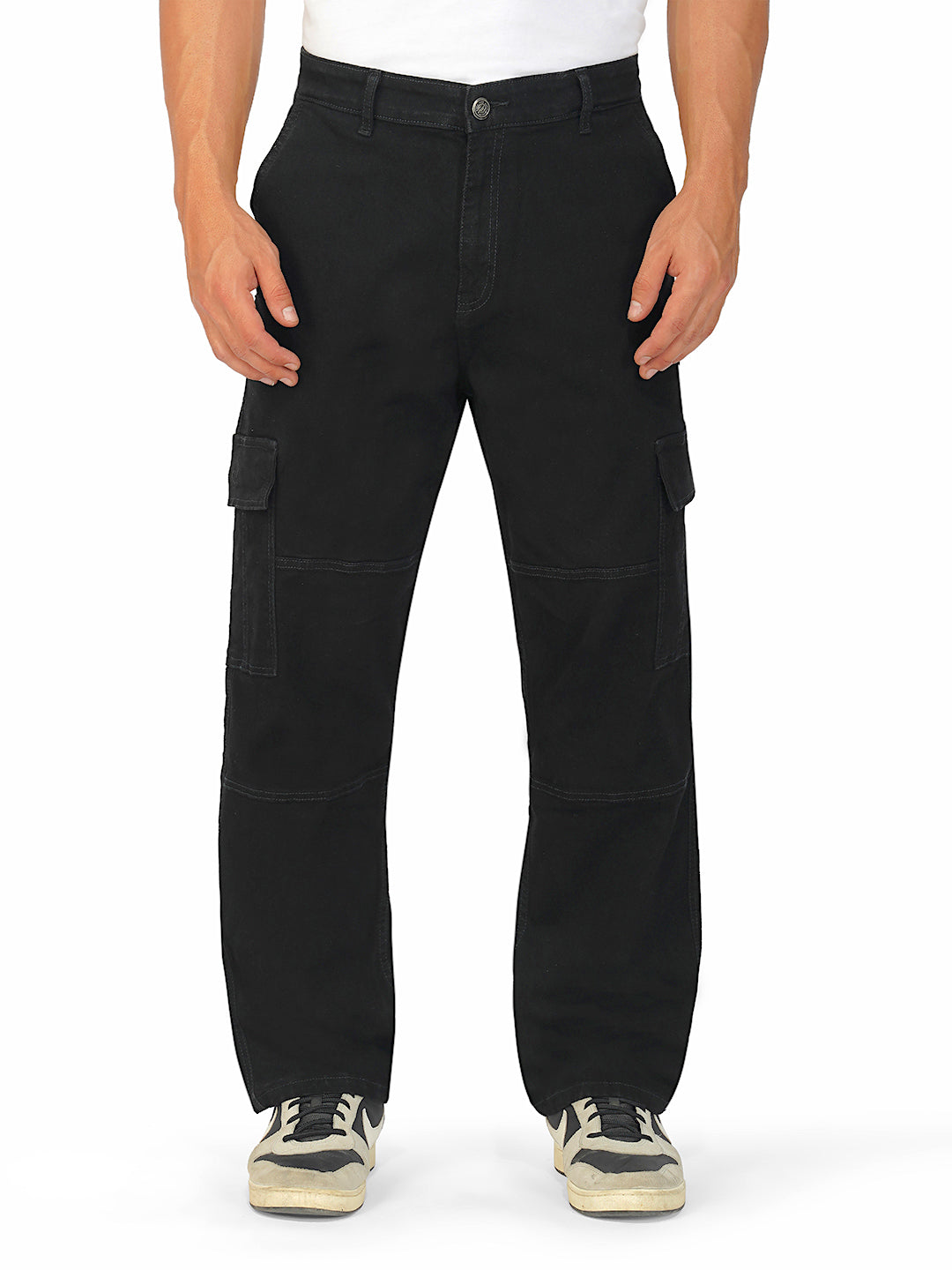 Model wearing black cargo jeans with utility pockets and relaxed fit